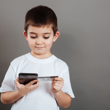 child looking at credit card credit monitoring